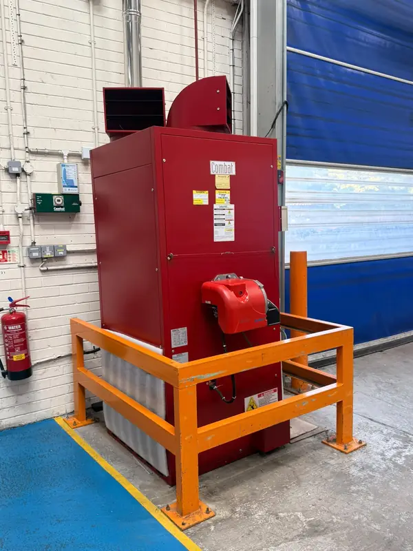 Combat oil-fired cabinet heater with a protective barrier