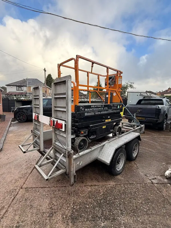 M&B branded scissor lift on its trailer